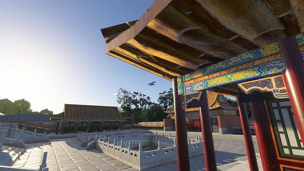 A scenic view of traditional Chinese architecture with a flying airplane in the background.