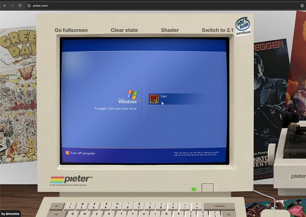 Screenshot of a vintage computer monitor displaying a Windows XP login screen with a retro computer setup including keyboard and posters in the background.
