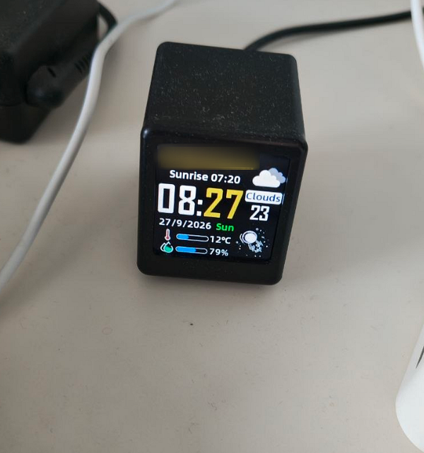 A smartwatch displaying the time 08:27 along with weather and date information.
