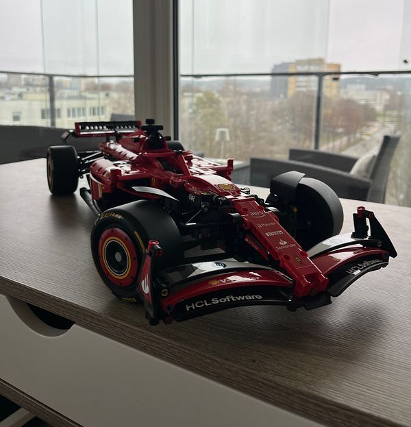 A detailed Lego model of a Formula 1 car is displayed on a wooden table.