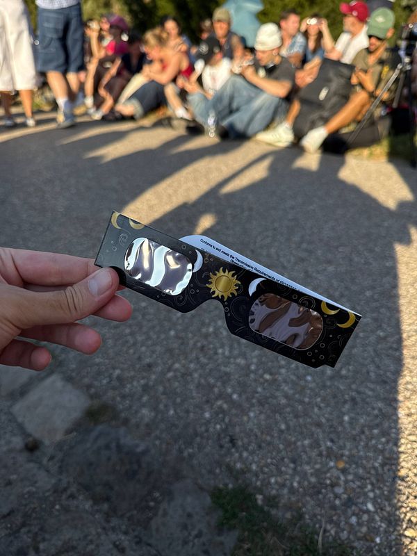 A composite image illustrating a solar eclipse with the moon partially covering the sun, along with explanatory text and diagrams.