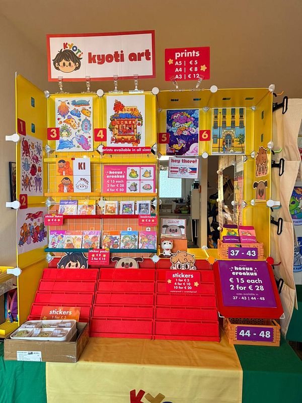 Corner booth setup displaying an array of products on wireframe shelves, showcasing new outsourced items for a practice setup.