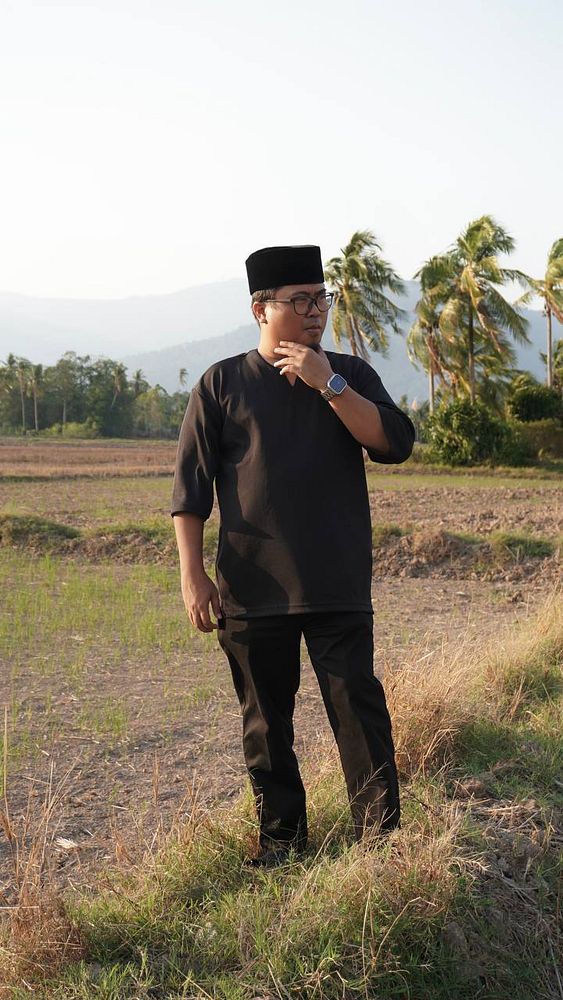 Portrait of a female model with dramatic lighting and makeup against a dark background.