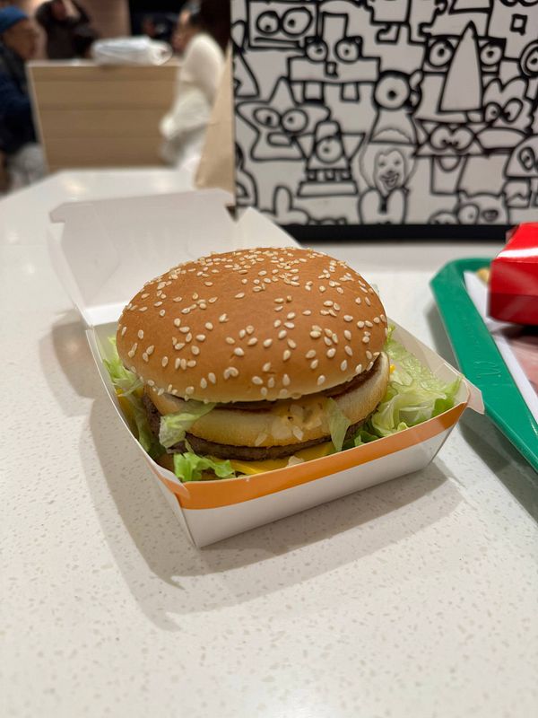 A Japanese Big Mac is presented in its packaging on a table.