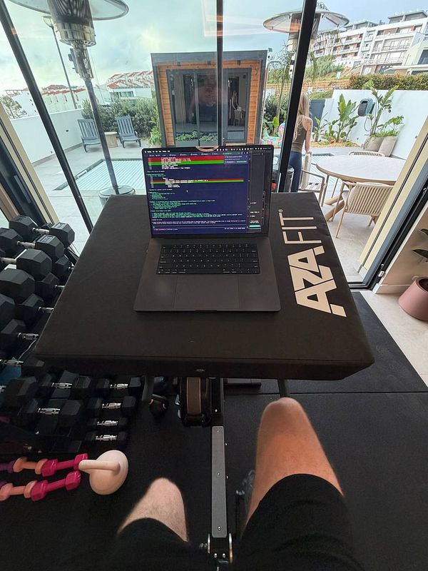 A fit young woman in athletic wear is running on a treadmill in a gym setting.