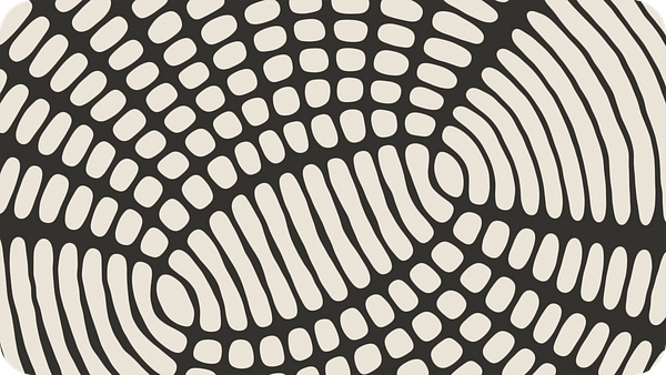 A colorful geometric repeating pattern with diamond and triangle shapes in pink, red, white, and gold.