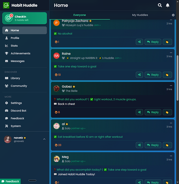 An umbrella with text design hung on a circular white railing with green plants in the background.