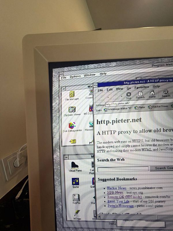 Close-up photograph of a CRT television screen displaying colorful, radiant light patterns.