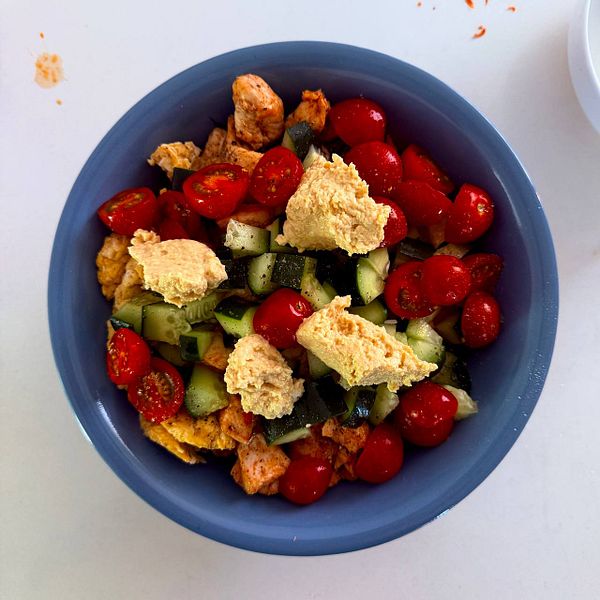 A vibrant mega breakfast bowl featuring a colorful variety of fresh fruits, nuts, and seeds.