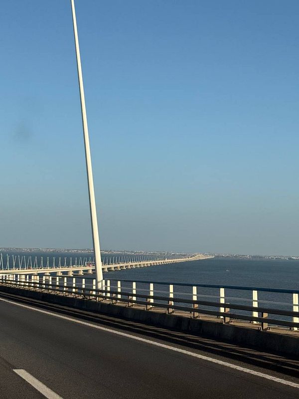 A scenic view of a bridge extending over a body of water in Portugal.