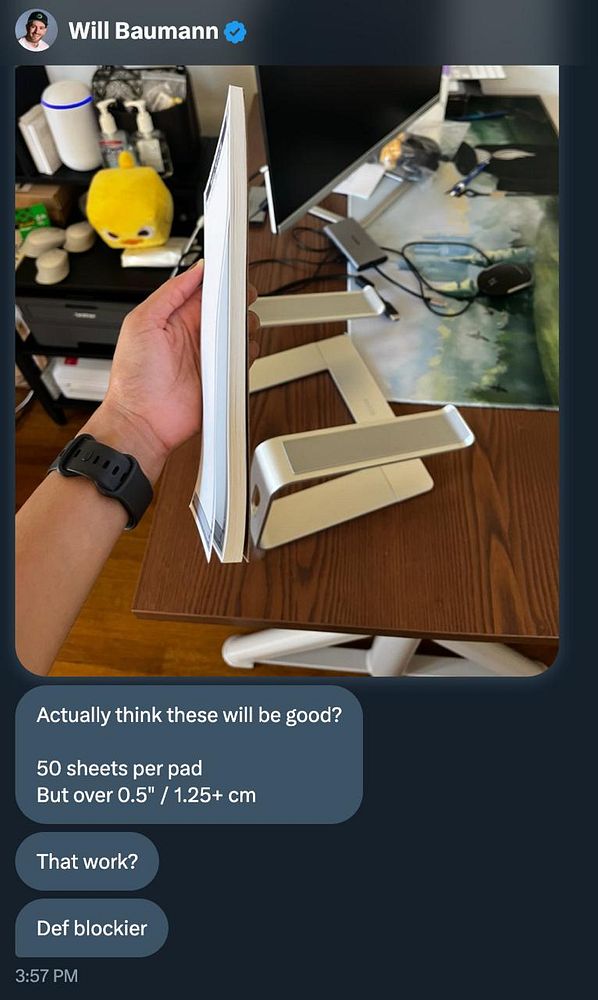 A person holds a notepad while discussing its specifications in a digital conversation.