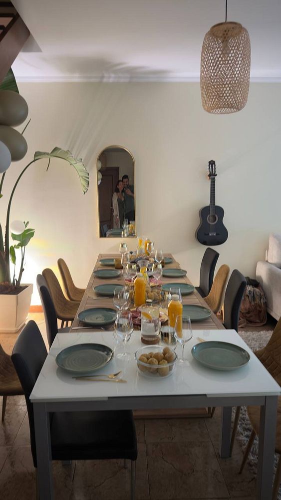 A beautifully set dining table ready for a raclette meal with family.