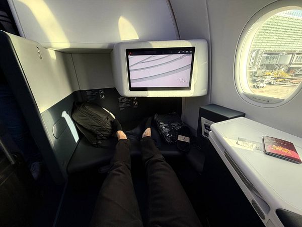 A spacious Air France business class seat with a large screen and personal amenities.