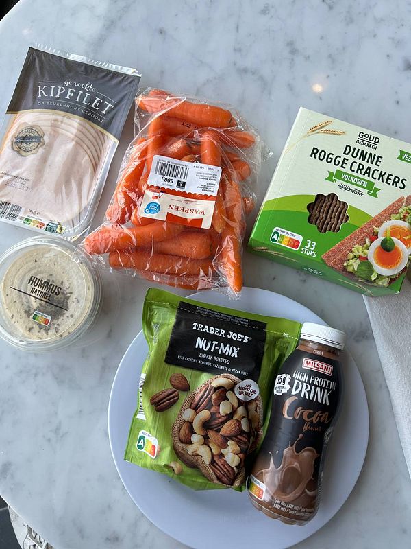 A selection of healthy snacks and food items arranged on a marble surface.