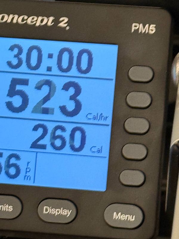 The image displays the monitor of a Concept2 rowing machine showing workout statistics.