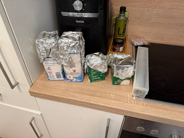 The image depicts a kitchen countertop with various food items and kitchen appliances.