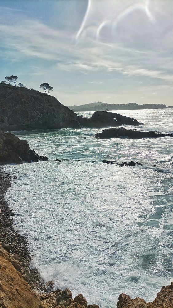 A person walking in a stormy, rainy urban street holding a transparent umbrella.
