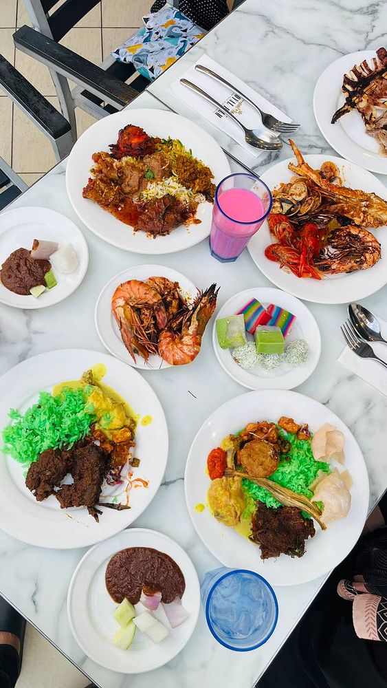 A nighttime cityscape with a focus on a tall, illuminated tower surrounded by city lights and tall buildings.