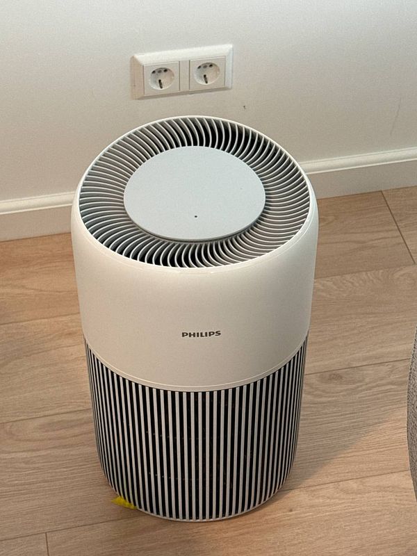 A photo showing an air purifier placed on top of an F7 climate system filtration unit in a home environment.