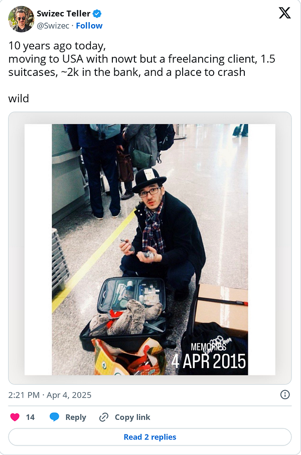 A man sits on the floor of an airport terminal surrounded by luggage, reflecting on his move to the USA.