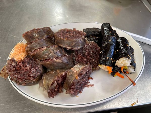 A plate of traditional Korean food featuring various types of rice rolls.
