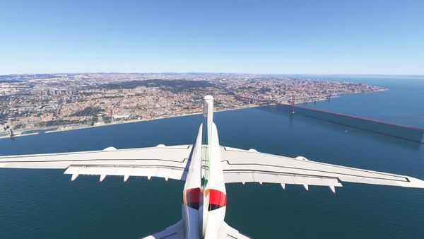 An aerial view of an A380 aircraft flying over Lisbon, showcasing the cityscape and the Tagus River.