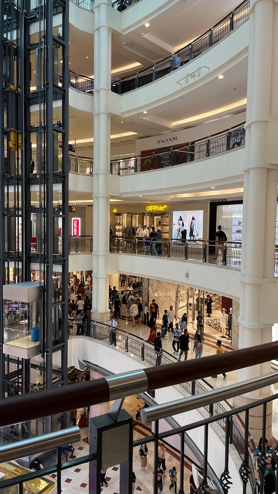 A bustling shopping mall in Kuala Lumpur with multiple levels and a variety of stores.