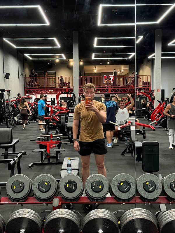 A woman performing a rope workout in a gym under professional training guidance.