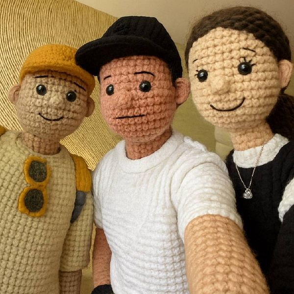 Three crocheted dolls pose for a selfie.