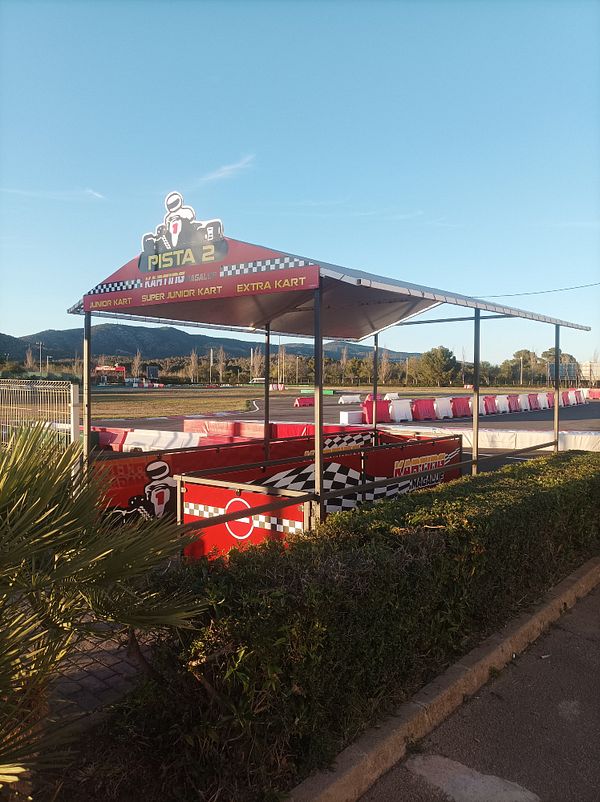 A go-kart track area with a covered waiting area and colorful karts.