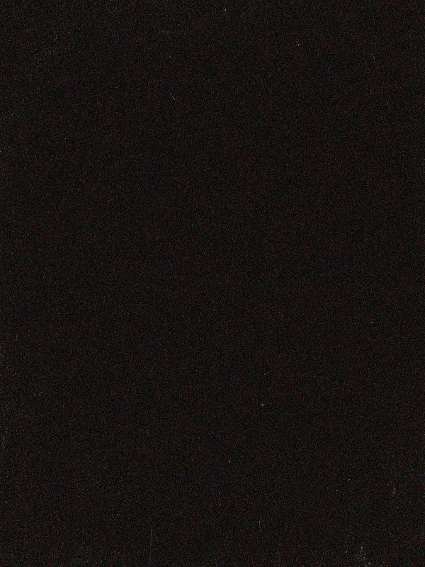 The image is a completely black photograph with minimal texture.