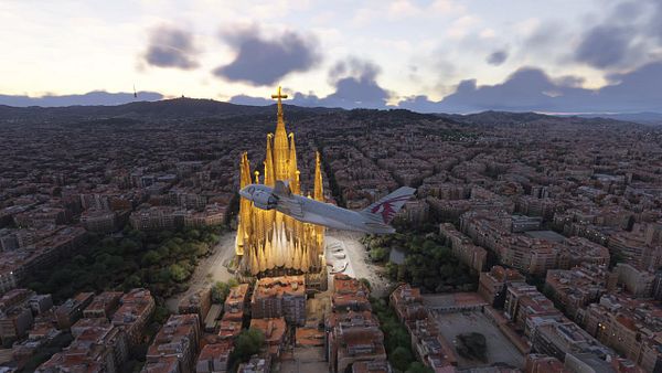 An aerial view of Barcelona featuring the Sagrada Família and an airplane flying overhead.