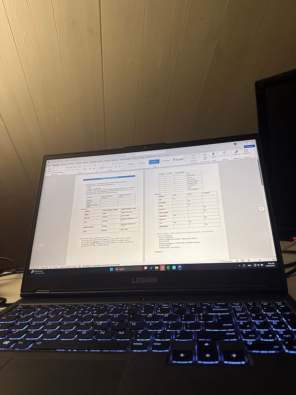 A laptop screen displays a document related to Database Management homework.