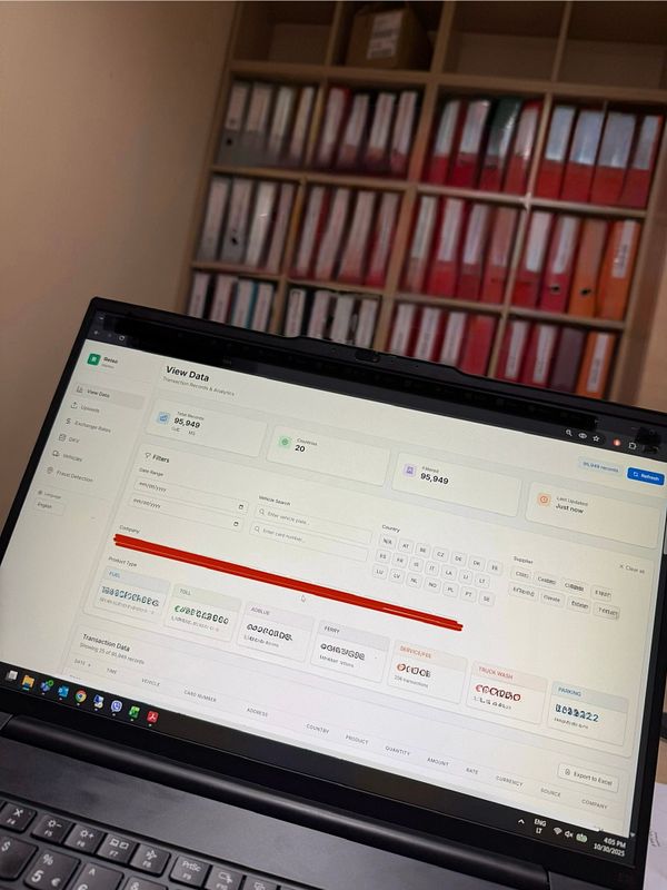 A laptop screen displays the 'View Data' interface of a Trip Expense System with various transaction details.