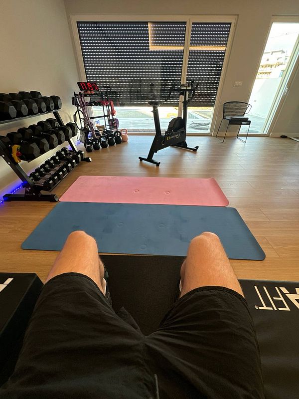 A home gym setup featuring exercise equipment and mats.
