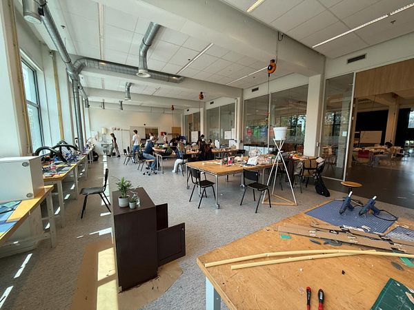 A spacious classroom filled with students engaged in various activities.