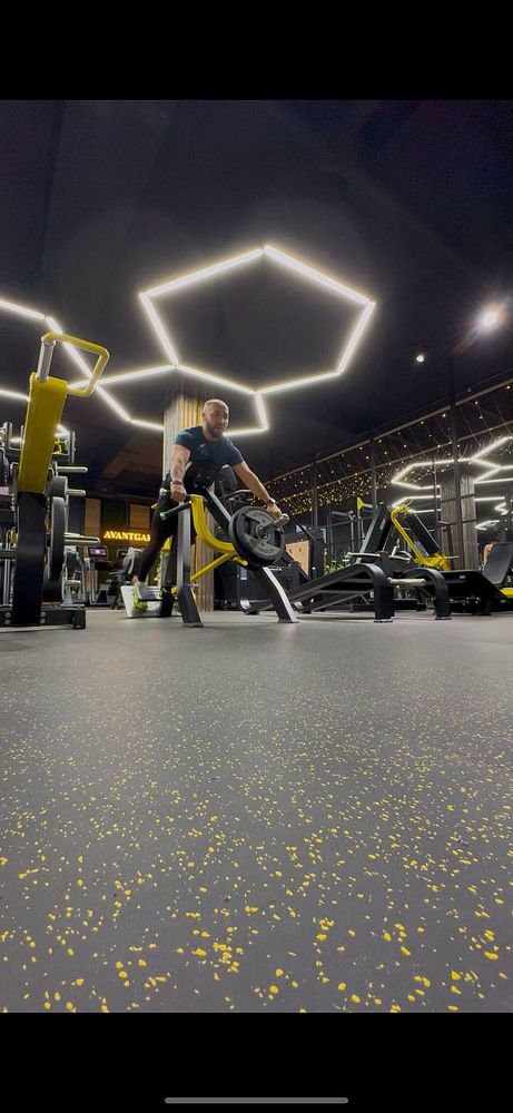 A person is performing a workout in a modern gym environment.