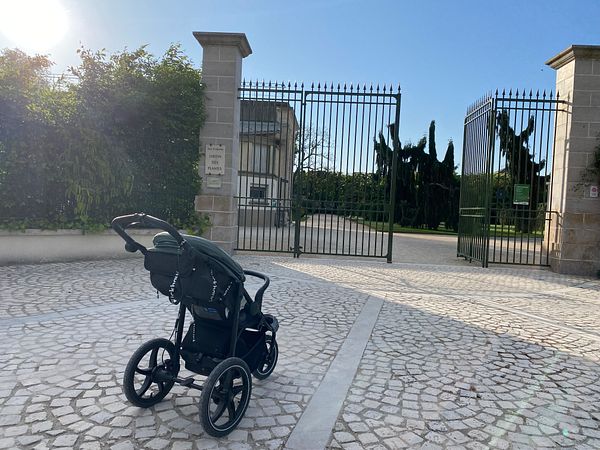 Scenic aerial view of a river winding through a lush green landscape with hills and clear blue sky.