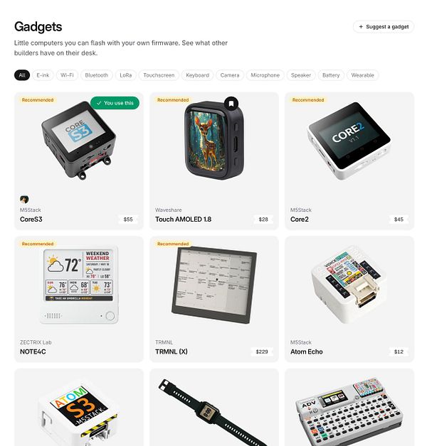 Collection of small electronic circuit boards and devices labeled as flashable gadgets for vibe coding projects.