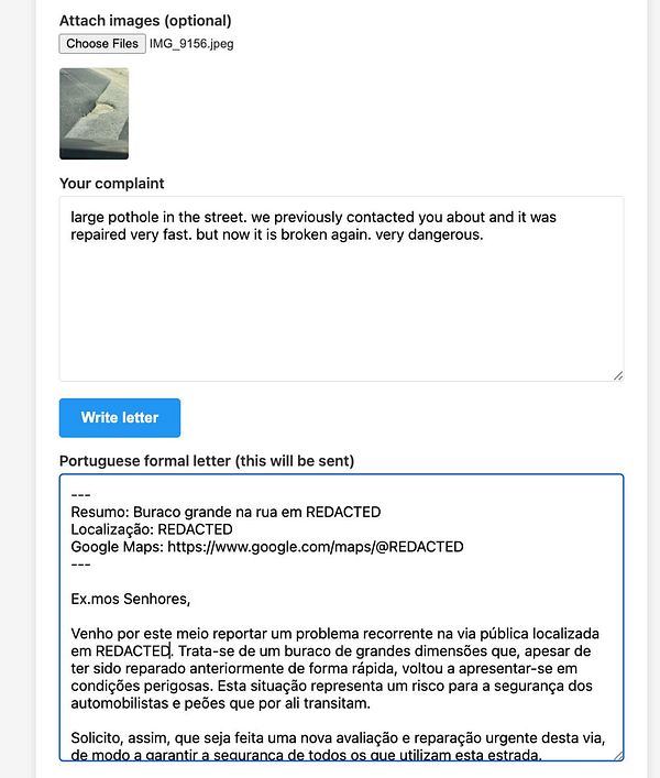 A street pothole marked with a makeshift barrier featuring a traffic cone and wooden sticks in a residential area in Portugal.