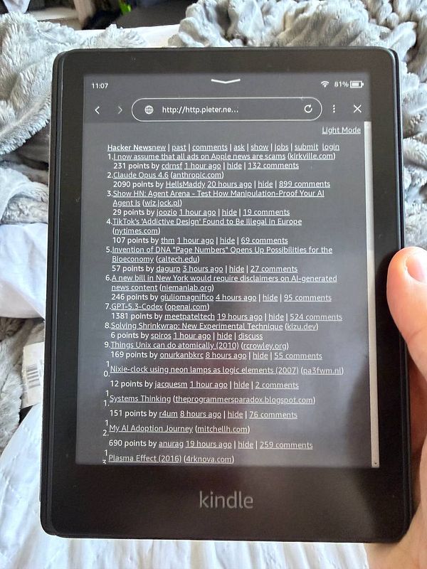 Screenshot of a Kindle device displaying an e-book page about black holes with black mode enabled.