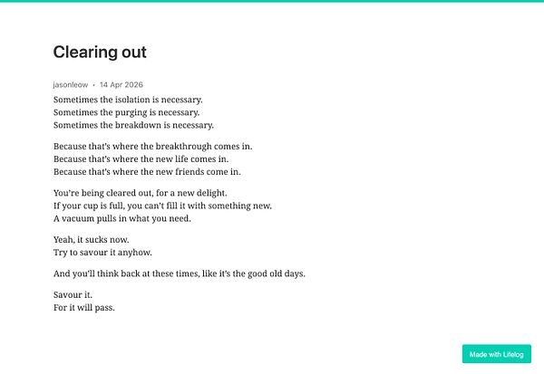 A cozy, warmly lit workspace featuring a notebook, pen, and a soft candle on a textured orange fabric background.