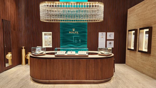 A luxurious Rolex boutique interior featuring elegant design elements and display cases.