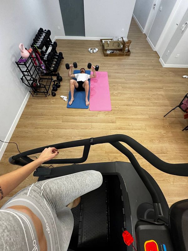 A person is performing a workout in a home gym setting.