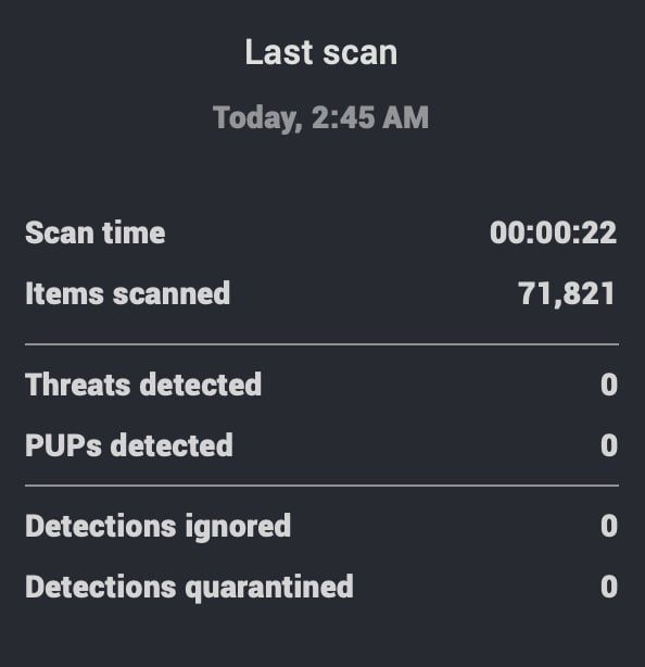 Portrait of a man with a beard wearing a patterned shirt against a plain background.