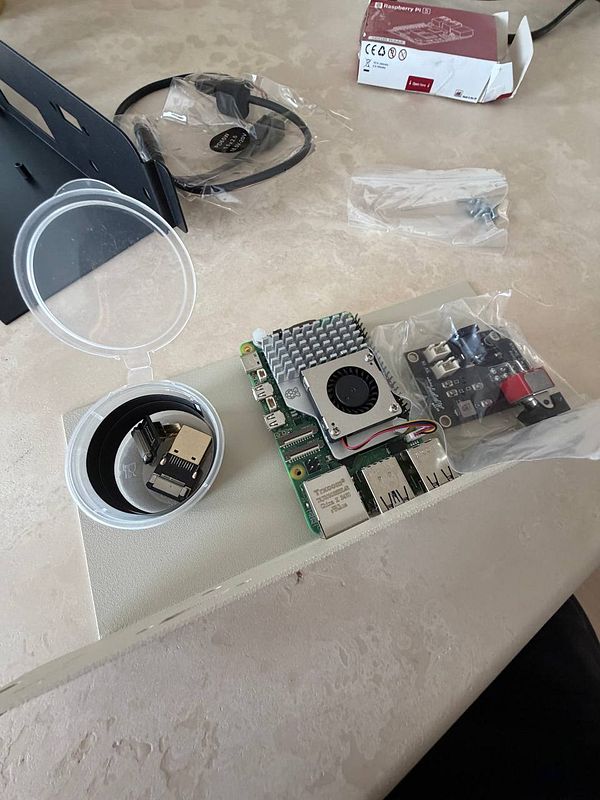 The image displays components for setting up a Raspberry Pi inside a vintage PC monitor.