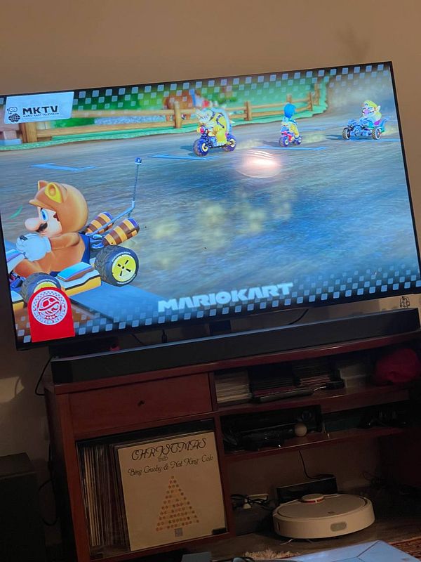 A scene from a Mario Kart game displayed on a television screen.
