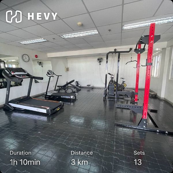 A gym interior featuring various workout equipment and workout statistics.